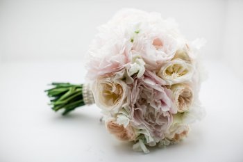 Fresh flower bridal bouquet of roses and peonies
